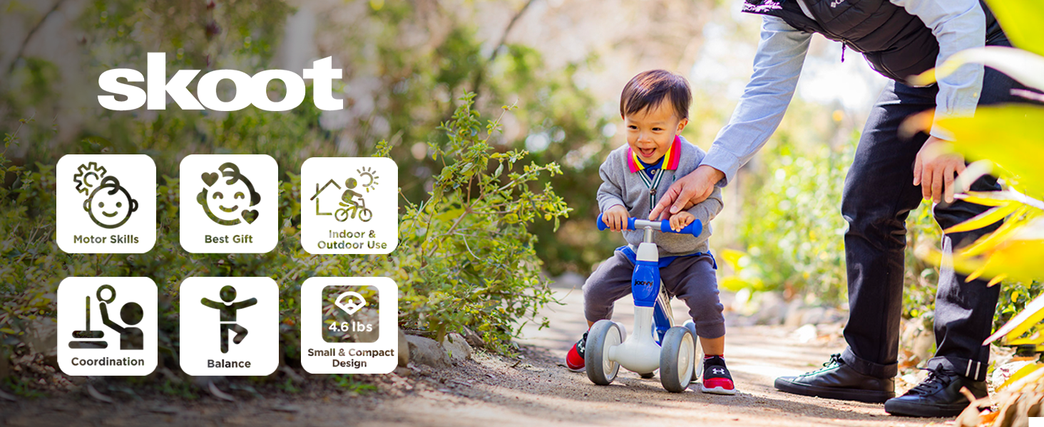 Happy toddler with parent using balance bike