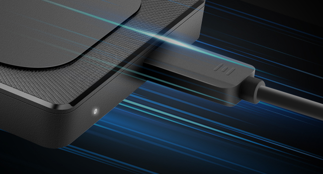 Black electronic device emitting blue light beams. Appears to be a data transfer or connectivity product with sleek design.