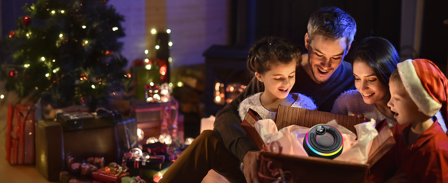 Warm evening scene showing a group gathered around glowing device with Christmas tree and decorative lights in background.