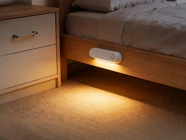 Series of images showing warm LED lighting installed under furniture, demonstrating motion-activated illumination in dark conditions.