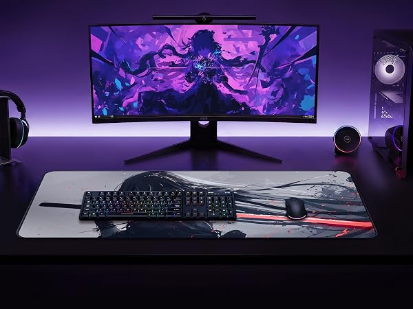Gaming desk setup featuring monitor displaying purple abstract visuals, mechanical keyboard, mouse, and speakers with ambient lighting.