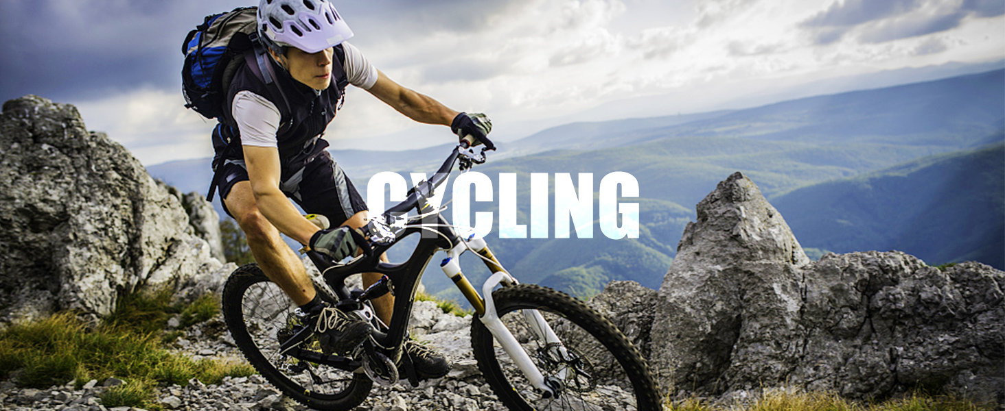 Mountain biker navigating rocky terrain on a mountain bike, wearing protective gear against dramatic mountain landscape backdrop.
