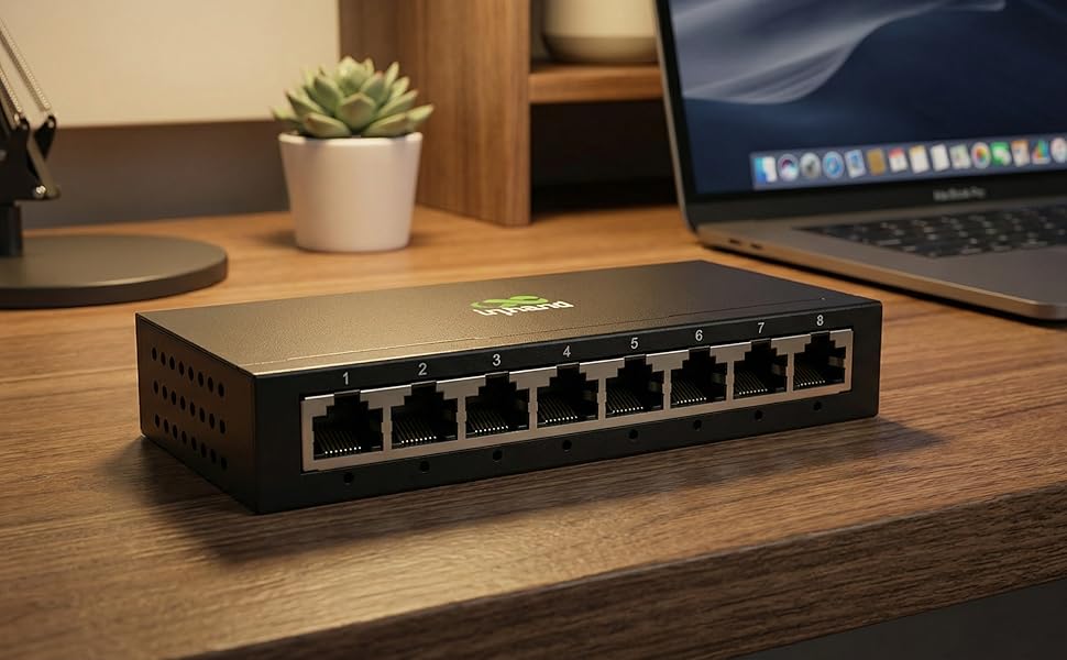 Network switch or router device shown on wooden desk surface with multiple ethernet ports visible in different lighting conditions.