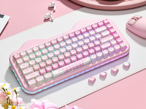 Pink and white mechanical keyboard photographed at angle, showing key switches and keycaps with white lettering on pink background, styled product photography setup.