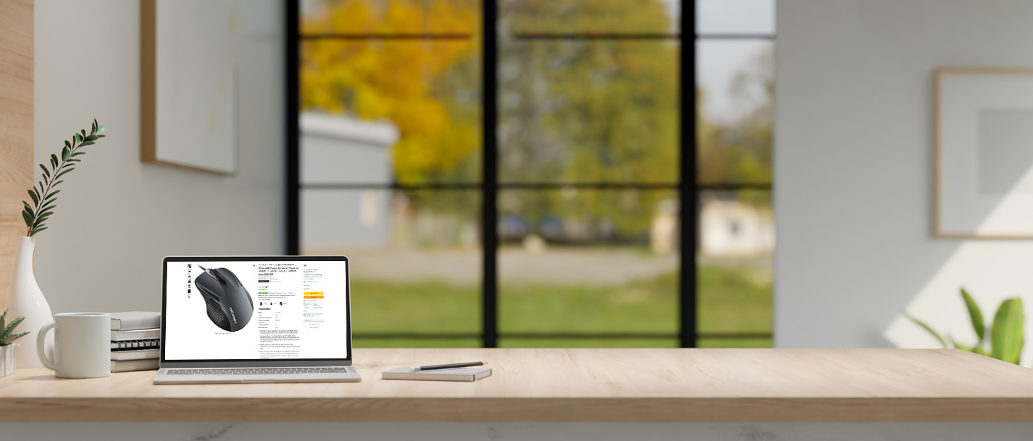 a laptop on a table with a view of a field