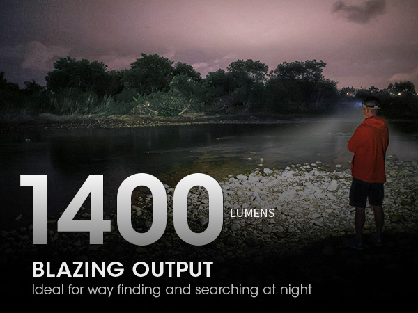 A man fishing on a riverbank at dusk. He wears a NU43 on his head.