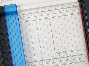 Inch and centimeter markings: Close-up of ruler guide with inch and centimeter markings for cuts