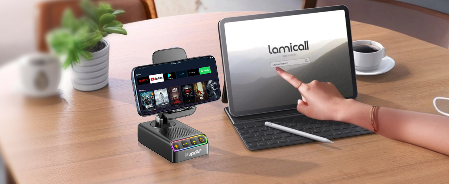 Text reads 'Lenzhub'. Setup showing tablet or laptop device with smartphone mounted on stand beside it on wooden desk surface.