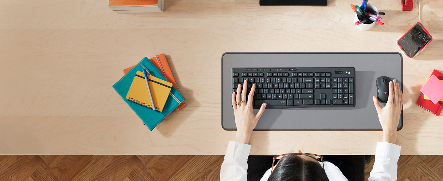 a zoom of a woman using mk295 wireless keyboard and mouse graphite combo