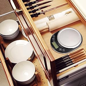 Makeup or cosmetics set in wooden organizer, featuring brushes, round compacts, and a cylindrical product.