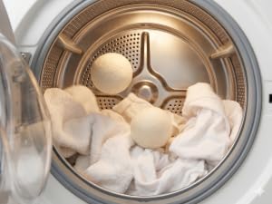 Wool dryer balls tumbling with laundry during drying