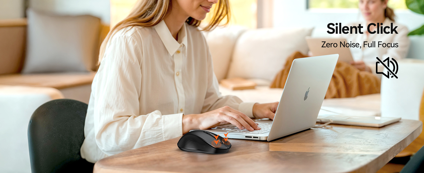 Person working on laptop with coffee mug and notebook on desk.