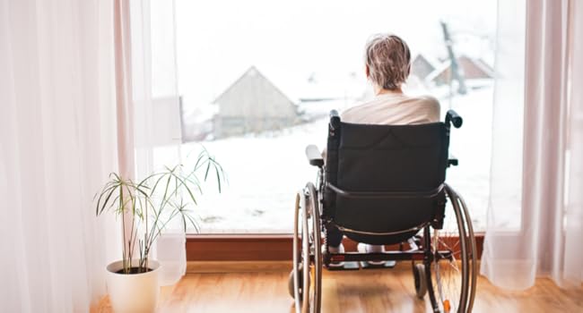 a women sitting on a wheelchair idicating a usage scenario of remote outlet plug
