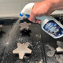 Spraying MiracleSpray for Cooktops and Microwaves