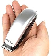 Compact silver hair trimmer shown in palm of hand, demonstrating its portable size and sleek metallic design.