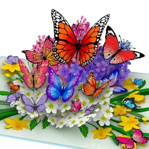 Colorful 3D pop-up card featuring multiple butterflies in various colors and sizes, surrounded by flowers and foliage. Vibrant orange, blue, and purple hues dominate.