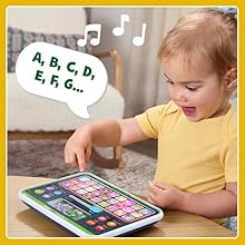 Kid singles along with songs playing on the toy tablet. A, B, C, D, E, F, G…