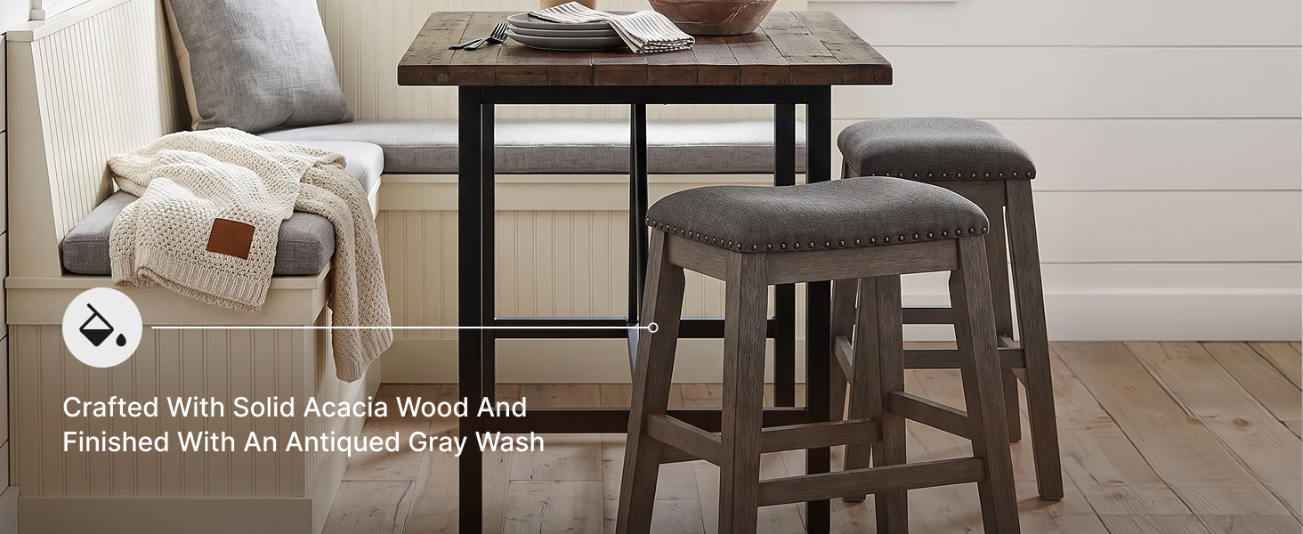 Close-up of the barstool seat highlighting textured gray polyester fabric and nailhead trim