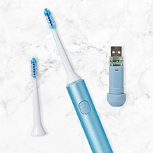 top down shot of REACH power toothbrush with USB charger