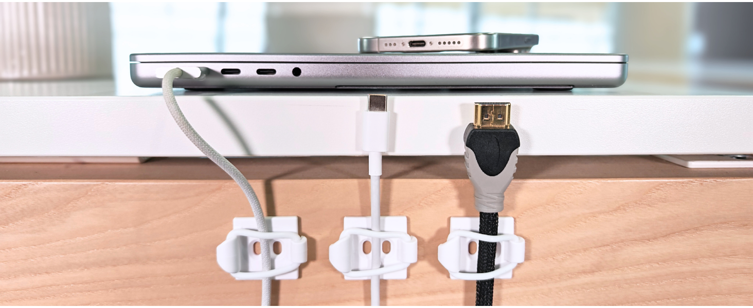 Cables secured on desk dext to laptop.