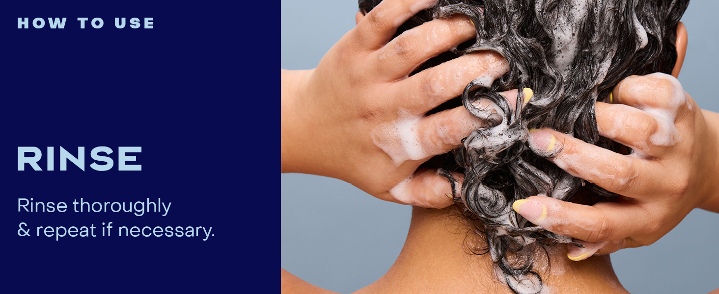 Image of a woman rinsing her hair with product.