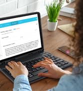 woman using a laptop computer on a desk