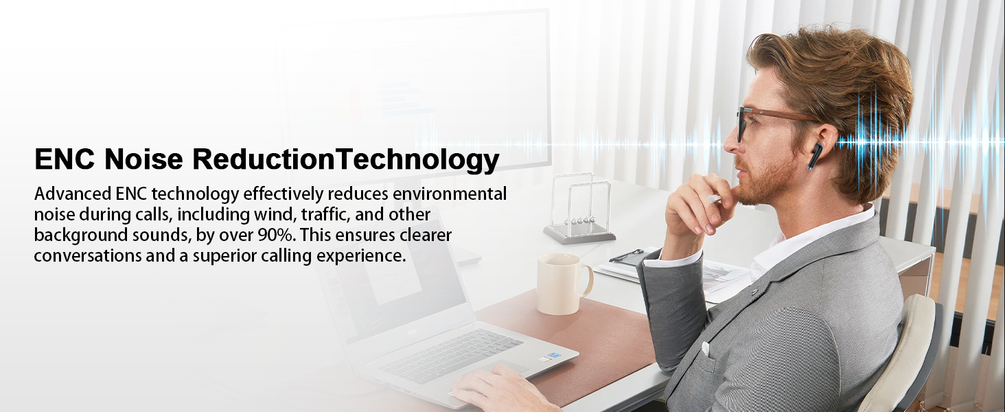 a man sitting at a desk with a laptop and a cup of coffee.