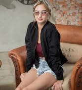 3.4 J+S Vision Hali Sunglasses - girl wearing round retro clear frame pink mirror lens sitting on a