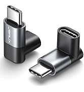 Two USB-C right-angle adapters in black and silver. L-shaped design with USB-C male connector on one end and female port on the other for 90-degree cable routing.