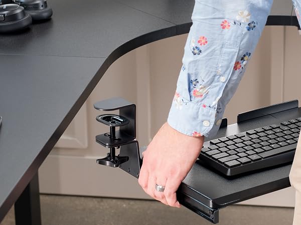 Man placing keyboard tray on desktop