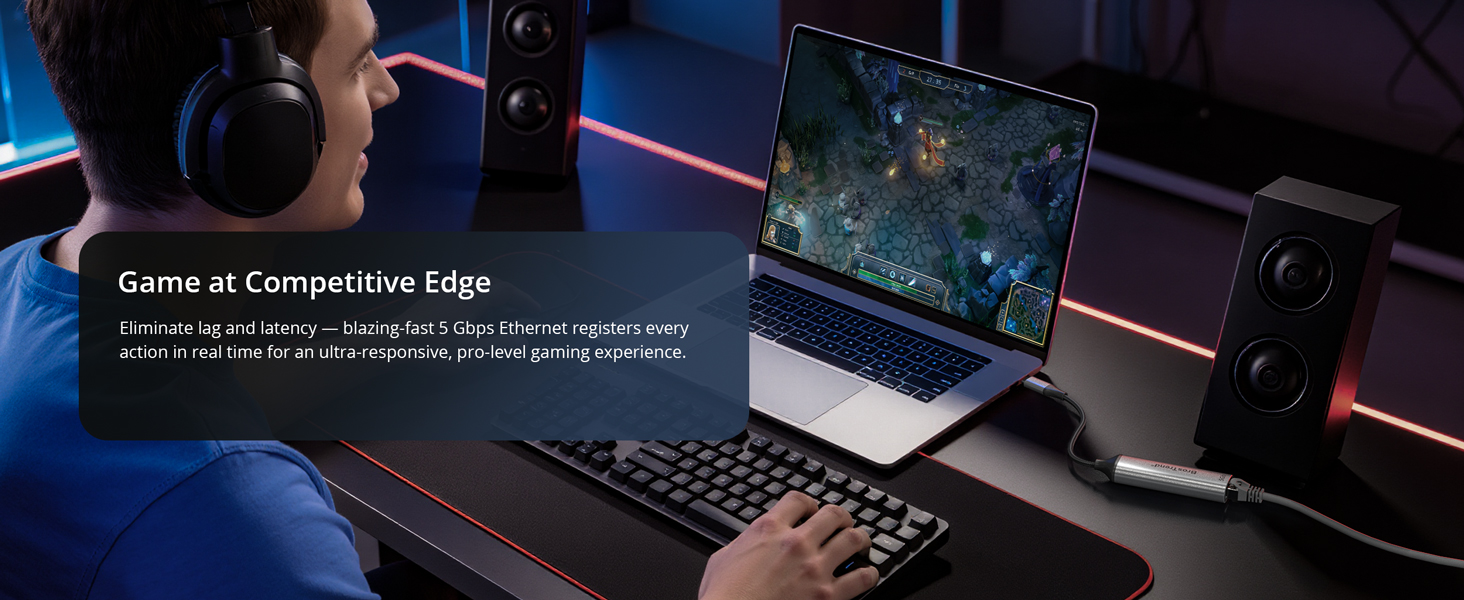 A Man Is Playing Online Game on a Laptop via USB-C to Ethernet Adapter