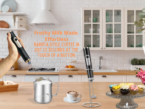 black milk frother foaming milk in a latte pitcher with frother on stand; cappuccino and cupcakes