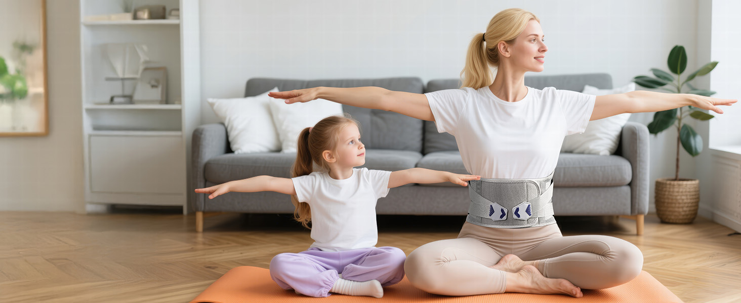 Two people practicing yoga on orange mats in a living room. They sit in lotus position with arms outstretched, showcasing flexibility and balance.