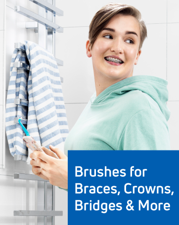 A girl with braces brushes her teeth with a specially designed TePe toothbrush for braces.