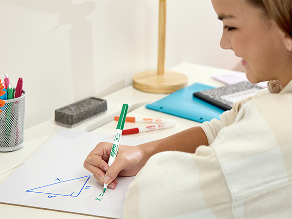 girl doing homework on board