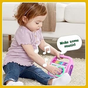 Kid plays with music player while music plays, and player says: Make some music!