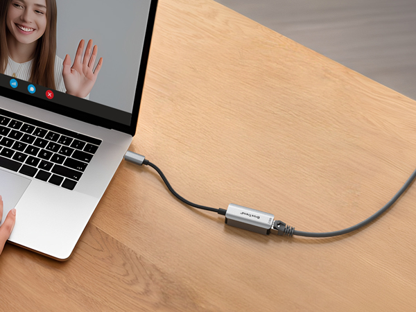A Woman Having Video Calls on a Laptop with the USB-C to 2.5G Ethernet Adapter Connected