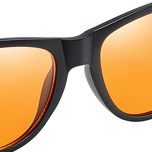 Close-up of sunglasses with black frame and orange-tinted lenses. Sleek, modern design with curved edges visible against orange background.