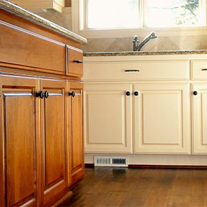Cabinets in a kitchen n wood and painted cream
