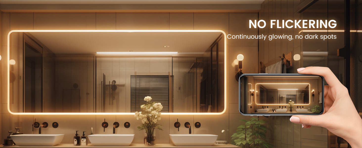 a bathroom with a large mirror and a plant.