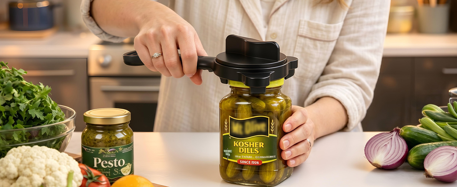 Heavy duty black 4-in-1 jar opener clamped on large pickle lid with stainless steel leverage.