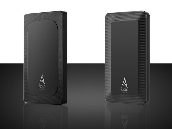 Two slim, black rectangular devices with rounded corners. Both have a small triangular logo. Shown from front and side angles on a reflective surface.