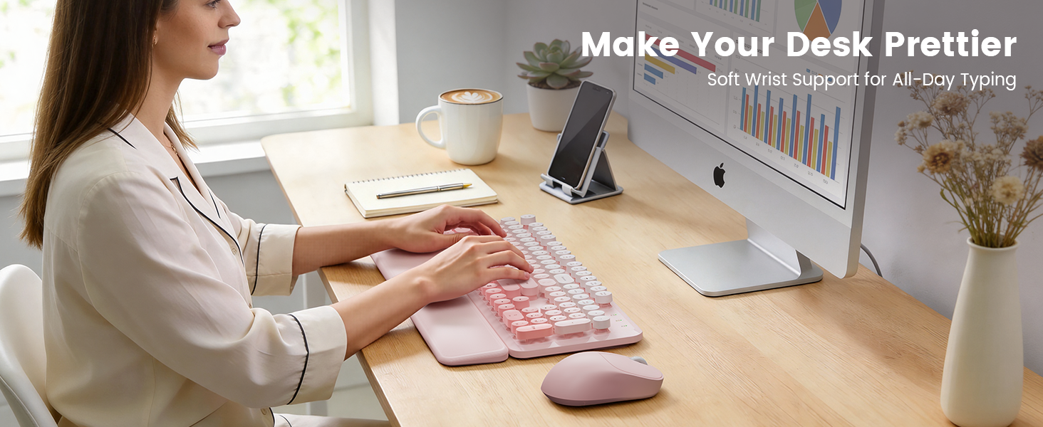 Woman typing on pink wireless keyboard mouse combo with wrist rest on tidy desk