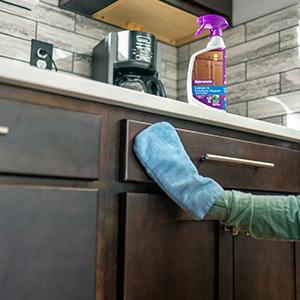 Hand in Microfiber Mitt wiping cabinet with Rejuvenate Cabinet &amp; Furniture Cleaner