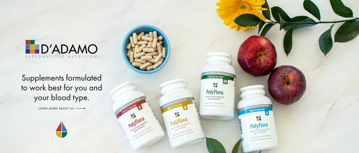 Blue bowl of capsules 4 bottles of polyflora supplements 2 red apples sunflower laid on white marble