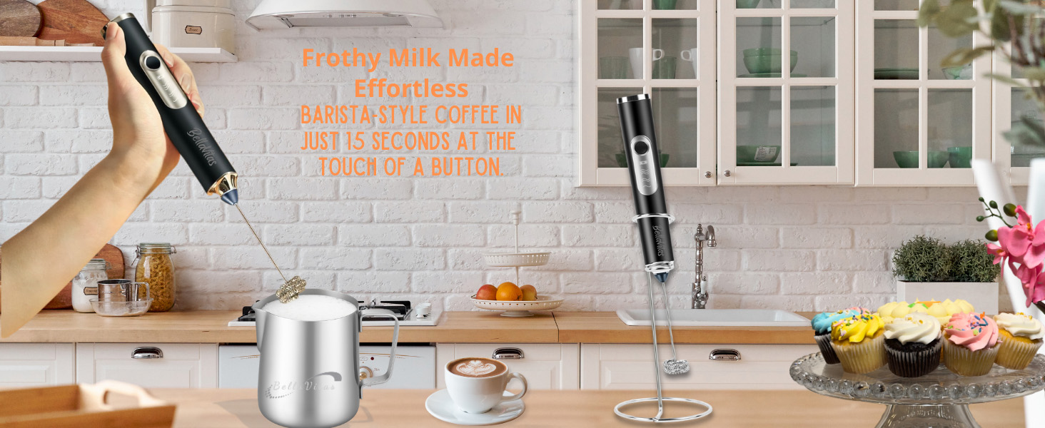 black milk frother foaming milk in a latte pitcher with frother on stand; cappuccino and cupcakes