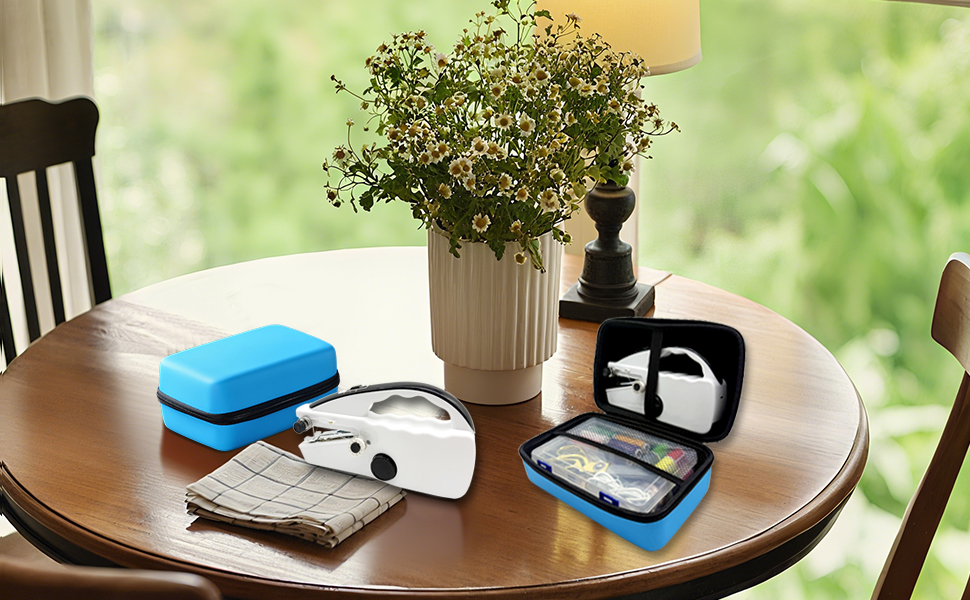A handheld sewing machine kit is placed on the table