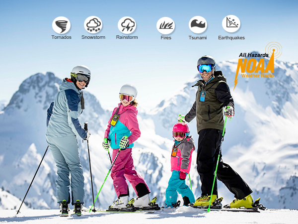 In front of snow mountain a family of four wearing ski gear smiling with walkie talkies rechargeable