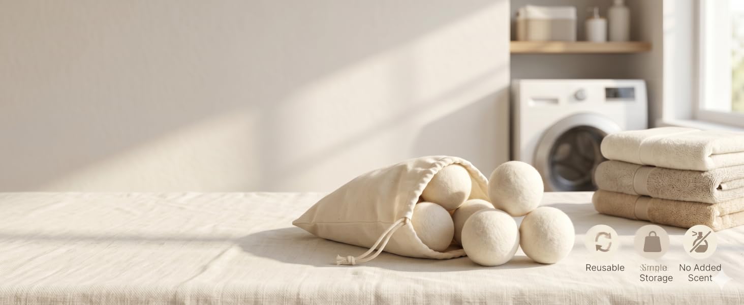 Reusable wool dryer balls stored in a cream cotton bag