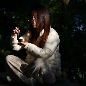 Closeup sequence showing hands holding and using what appears to be paper or card materials in a crafting or creative context.